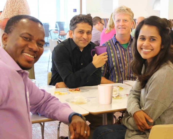 A diverse group of employees sitting at a table together