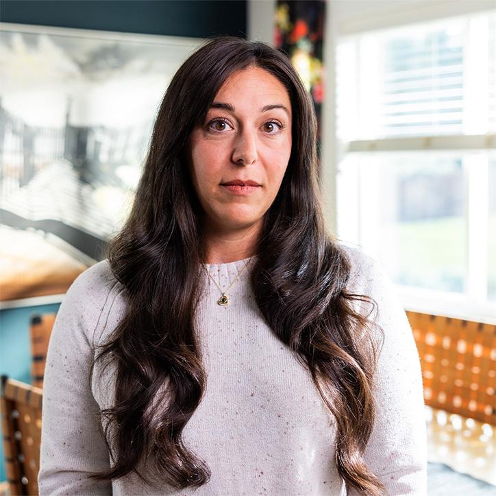 An image of Ali Burton looking at the camera with a serious look on her face.
