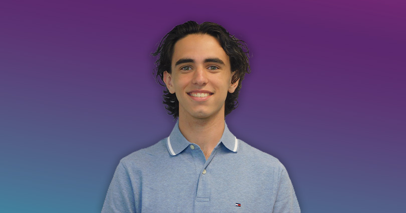 An image with a purple background of Brandon Douglas smiling.