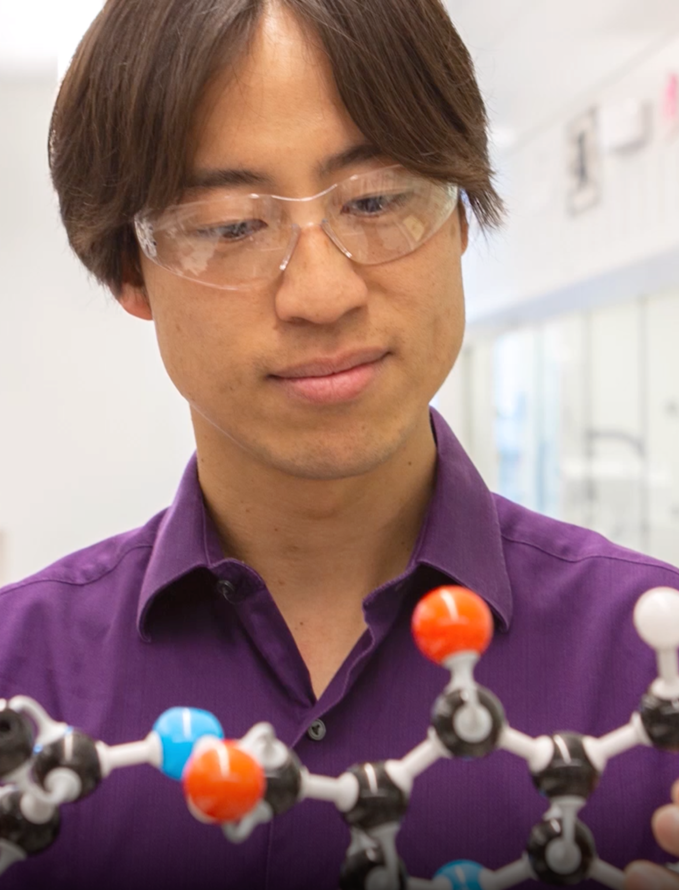 An image of a Vertex scientist look at a molecular structure model