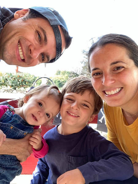 An image of Andrew Cournoyer taking a selfie alongside his partner and two children.