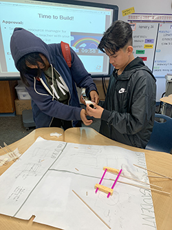 Two STEM students collaborating on a project together