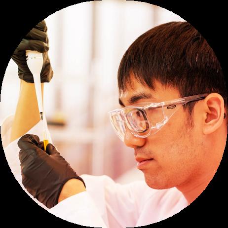 Male scientist in science labe holding pipette