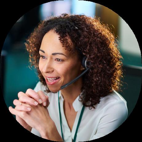 An image of a woman talking on the phone with a headset clasping her hands