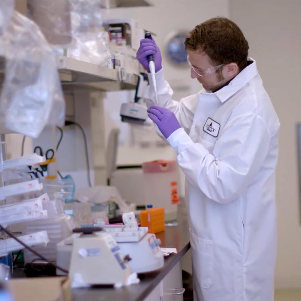 An investigator using a pipette in the lab