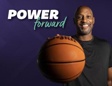 An image of Alonzo Mourning holding a basketball with the "Power Forward" logo next to him