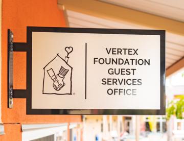 An image of a sign for the Vertex Foundation Guest Services Office