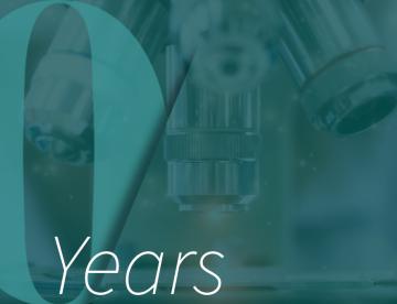 microscope with "10 Years" text over it