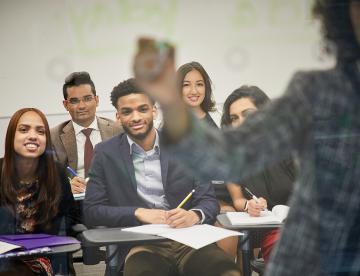 A class of students paying attention to the teacher