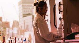 A Vertex scientist operating equipment in the lab