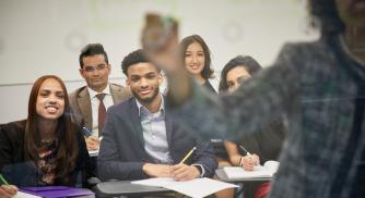 A class of students paying attention to the teacher