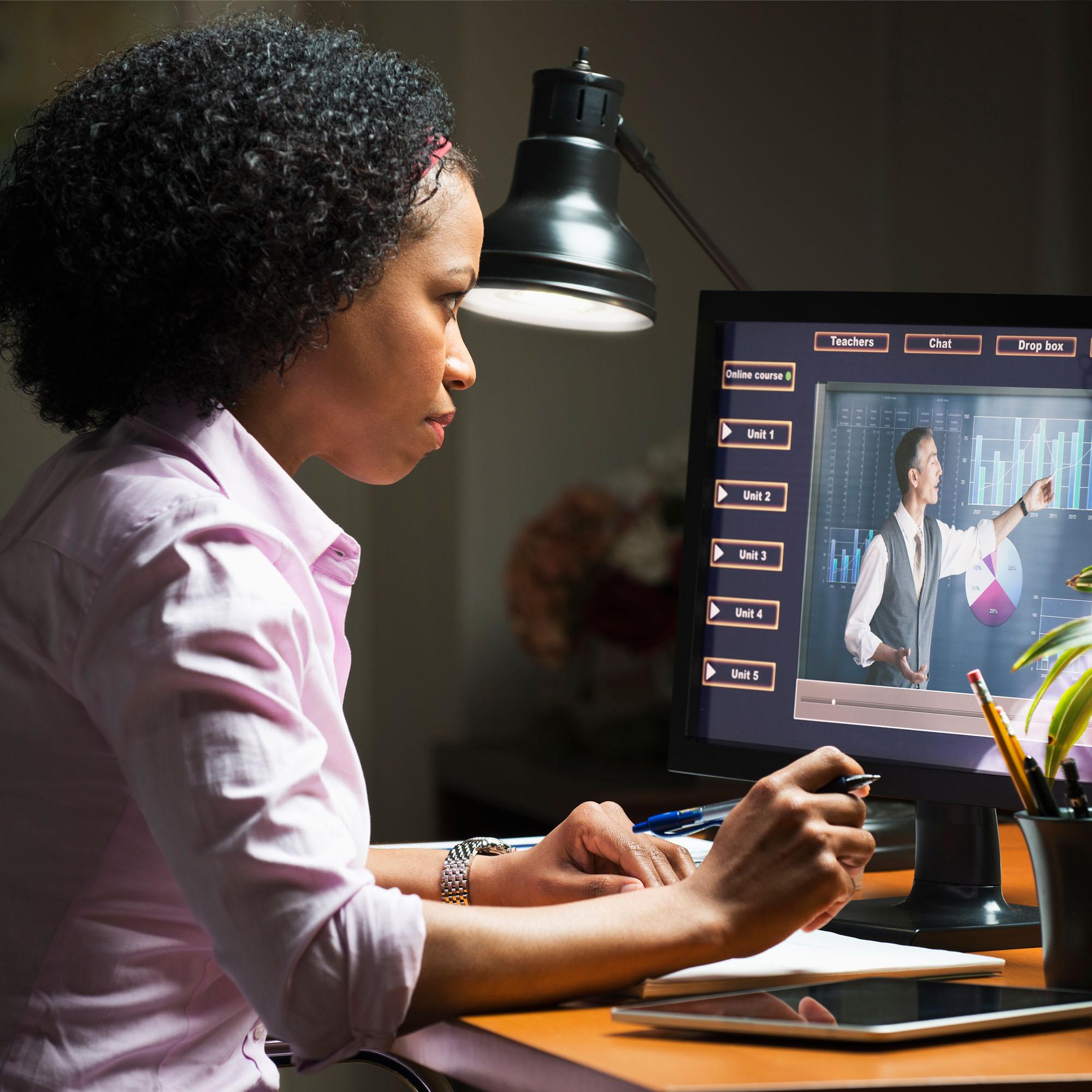 A woman taking a class online