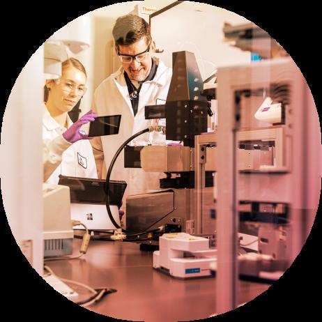 Male and female scientists observe scientific instruments