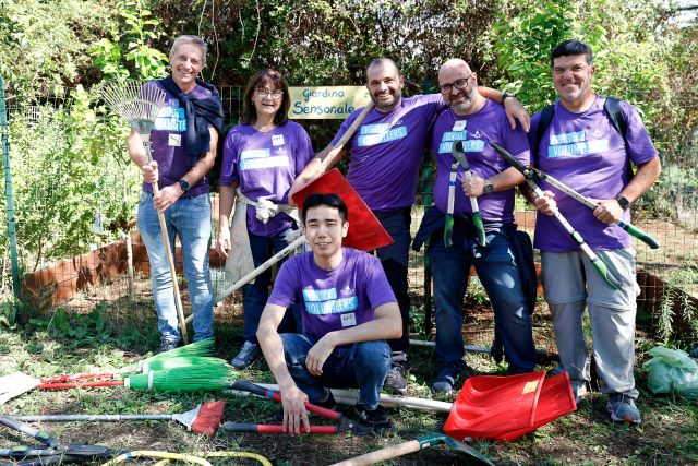 An image of six Vertexians wearing marching purple Vertex Volunteers shitrts while volunteering during the Vertex Week of Service.