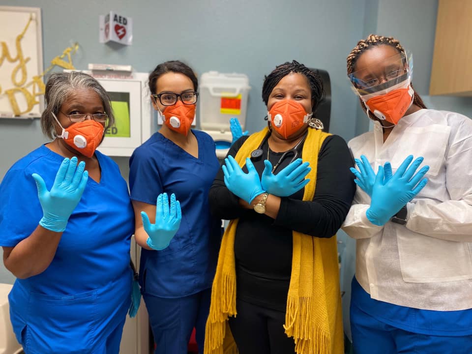 Health care workers showing their personal protective equipment