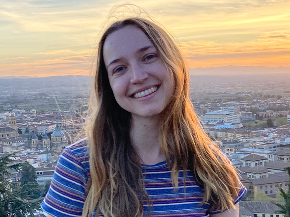 An image of Vertex Foundation Scholarship winner Kayley Eshleman smiling with a city in the background