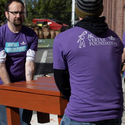 Vertex volunteers help move furniture for a non-profit company