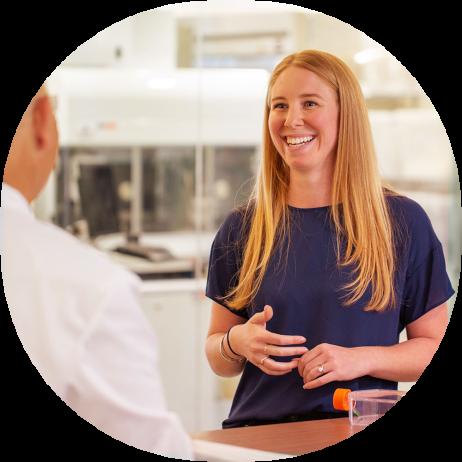 Female scientist speaks with business partner