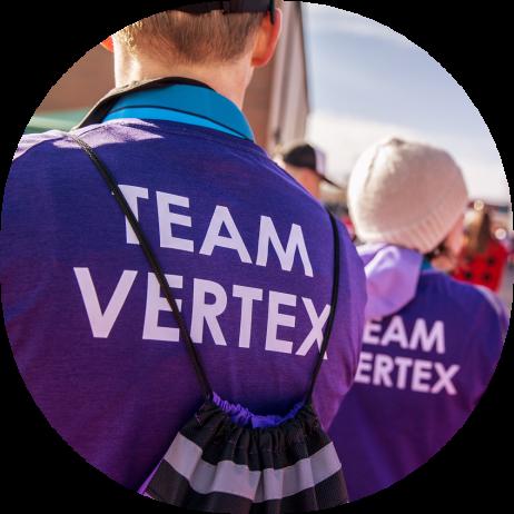 The backs of 2 Vertex employees wearing Team Vertex tshirts