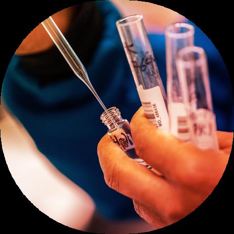 close up of a pipette being inserted into a vial