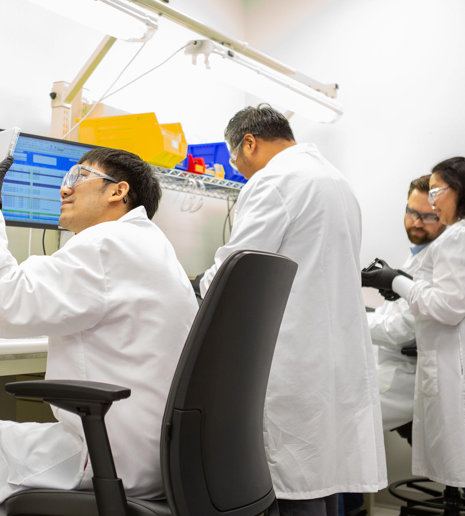 Collaboration between multiple Vertex scientists in the lab