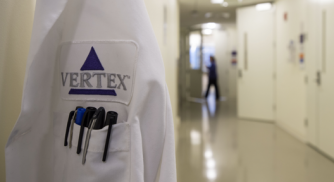 Image of a Vertex lab coat with pens in the pocket