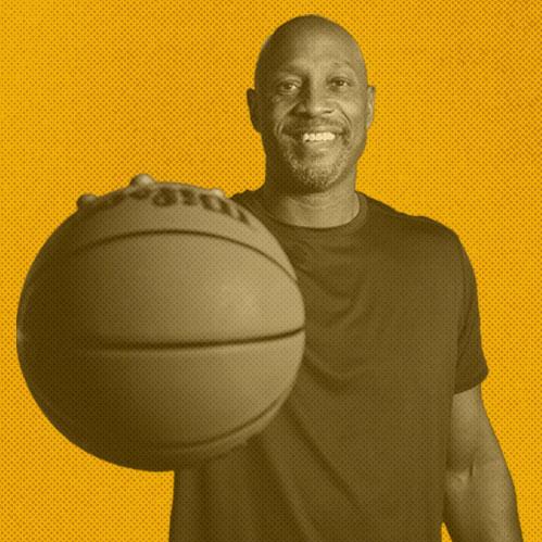 An image of former NBA player Alonzo Mourning holding a basketball in his right hand with a yellow overlay