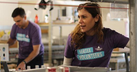 A Vertex employee volunteering at a food bank